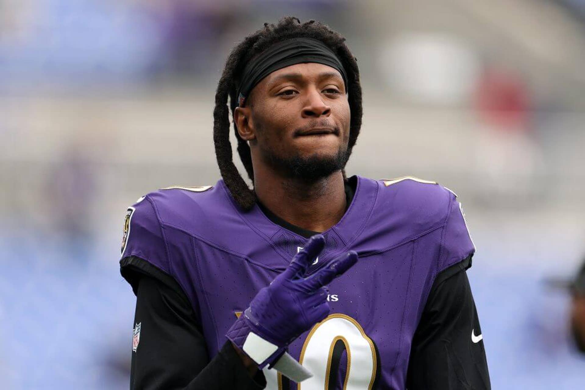 DeAndre Hopkins holds up two fingers with his right hand while wearing a Baltimore Ravens uniform.