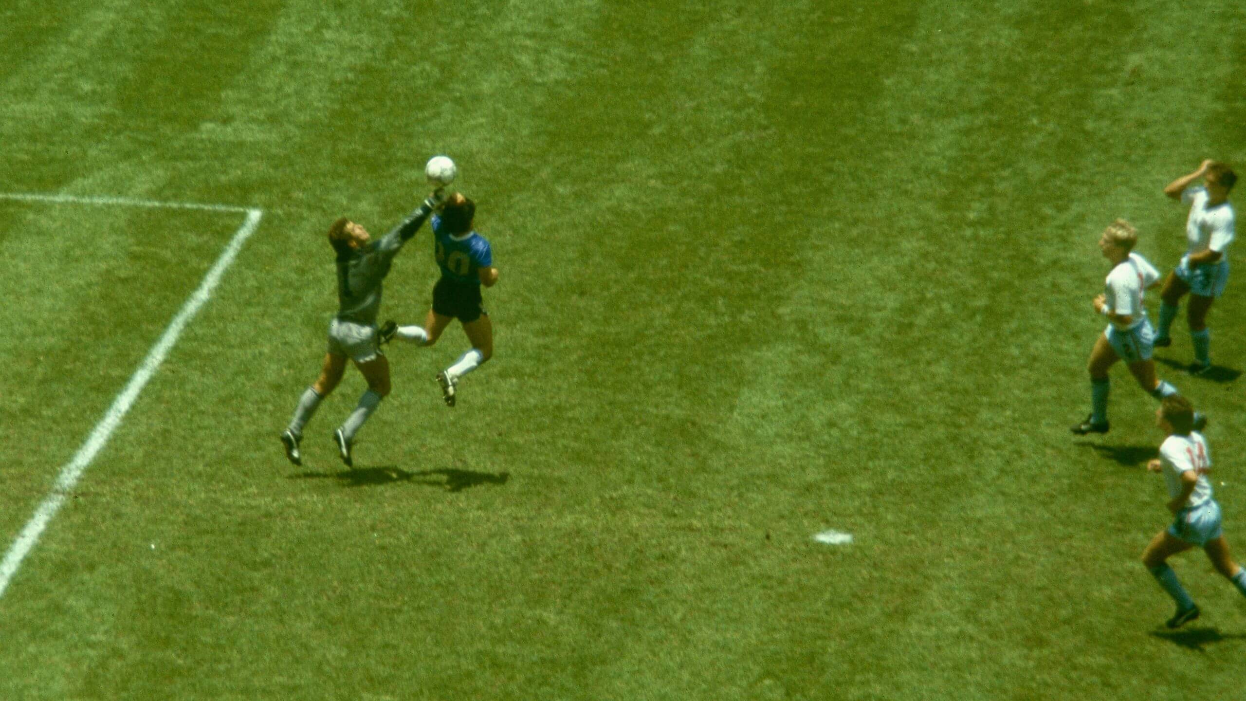 Diego Maradona uses his hand to score against England goalkeeper Peter Shilton during the 1986 FIFA World Cup quarterfinal at Azteca Stadium on June 22, 1986, in Mexico City.