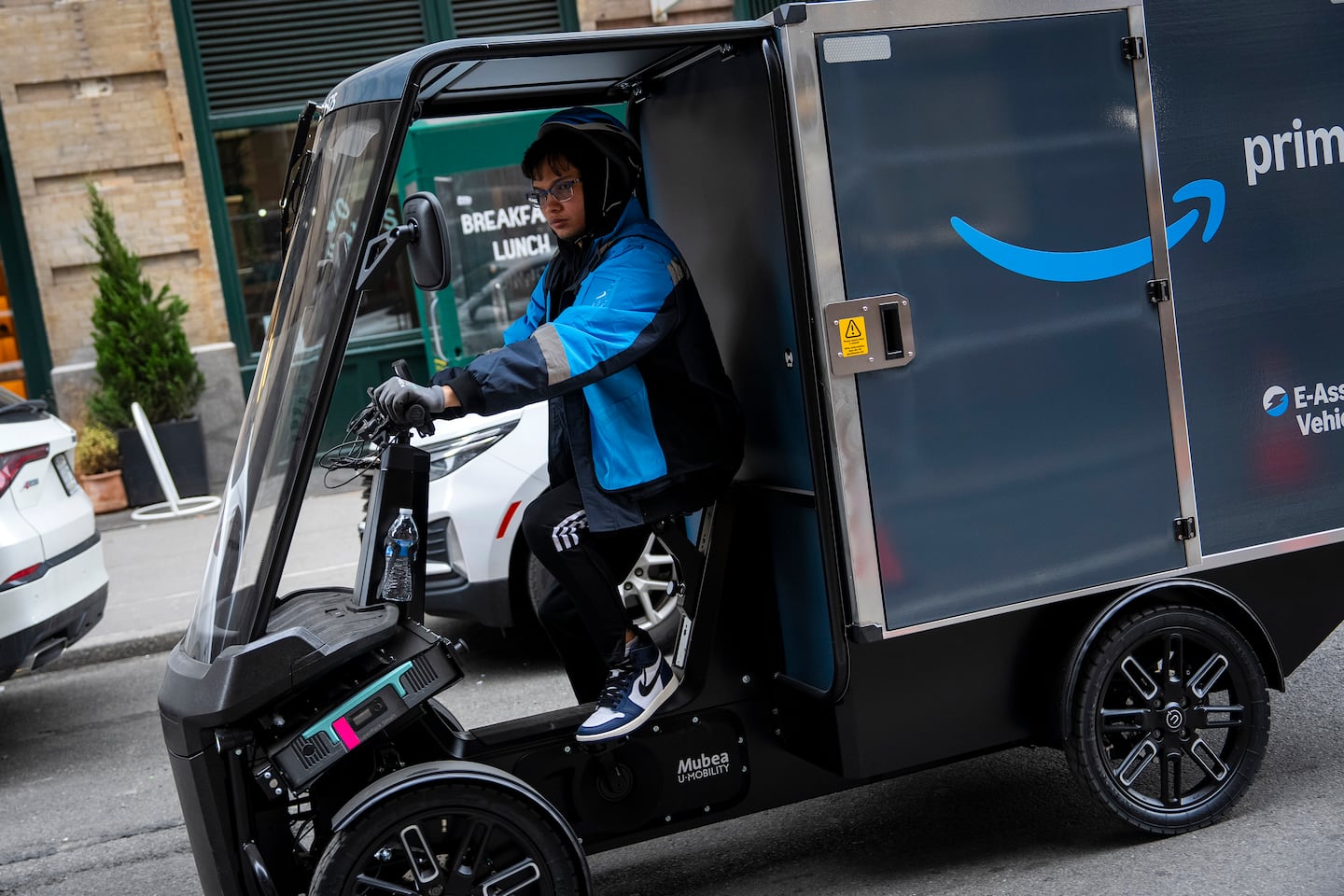 A worker makes Amazon deliveries in New York on March 19.