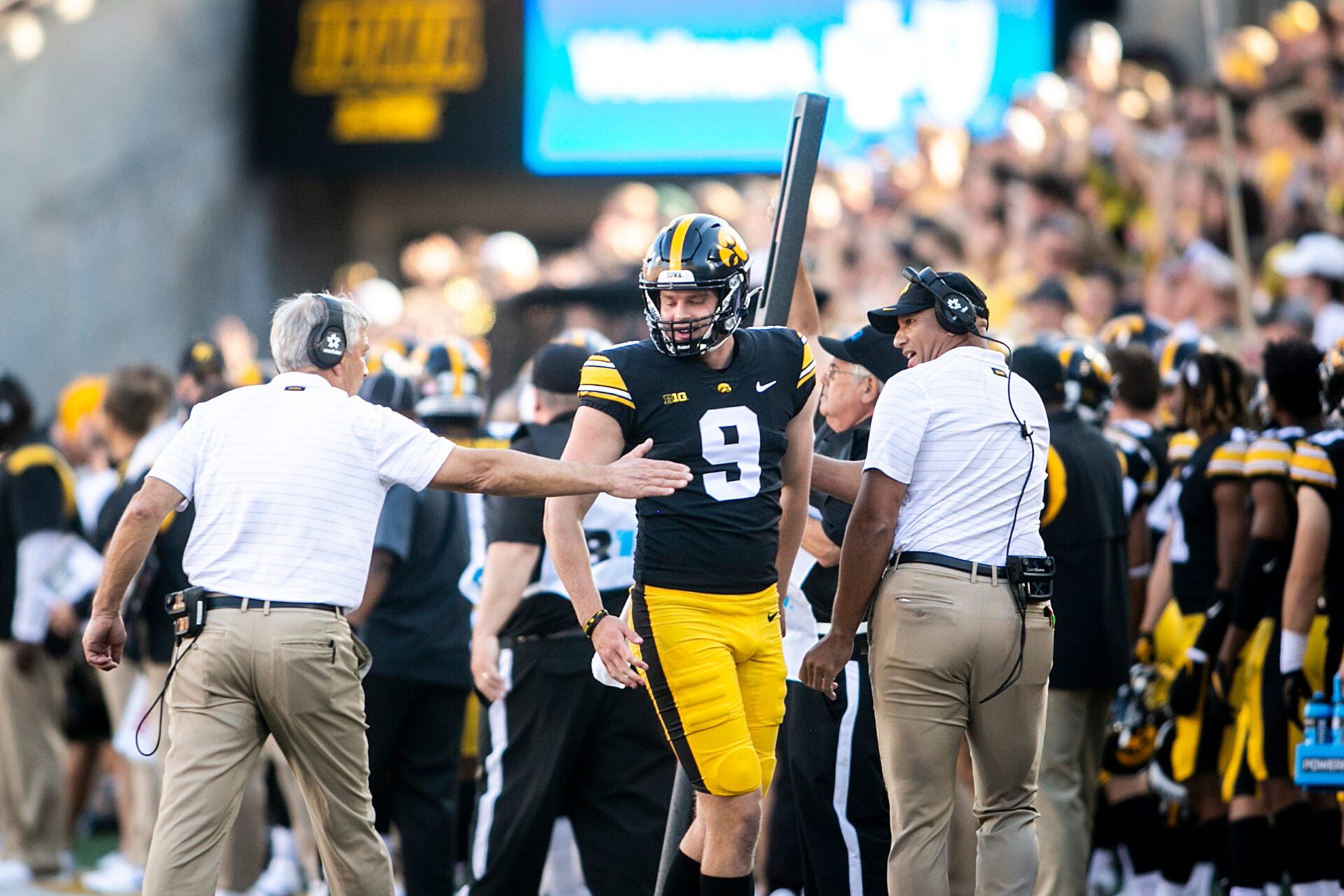 Iowa's Tory Taylor (9) gets a high-five from Iowa head coach Kirk Ferentz, left, while celebrating a punt with special teams