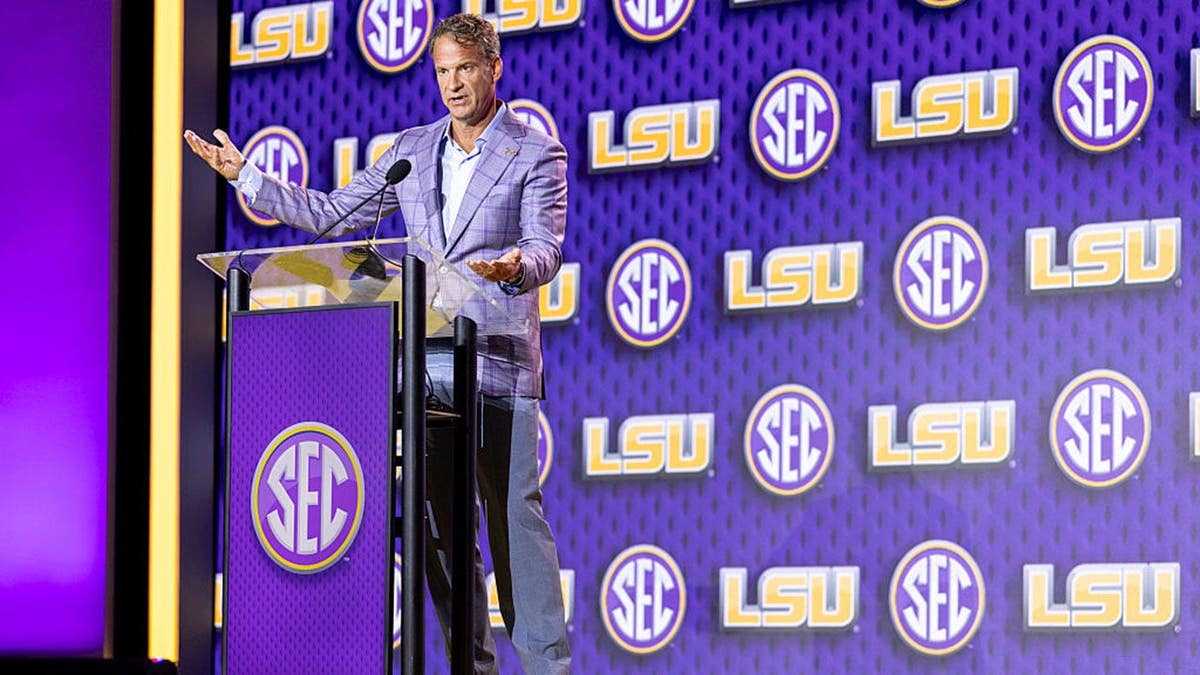 Lane Kiffin, LSU head coach, speaks at a podium during SEC Football Kickoff Media Day.