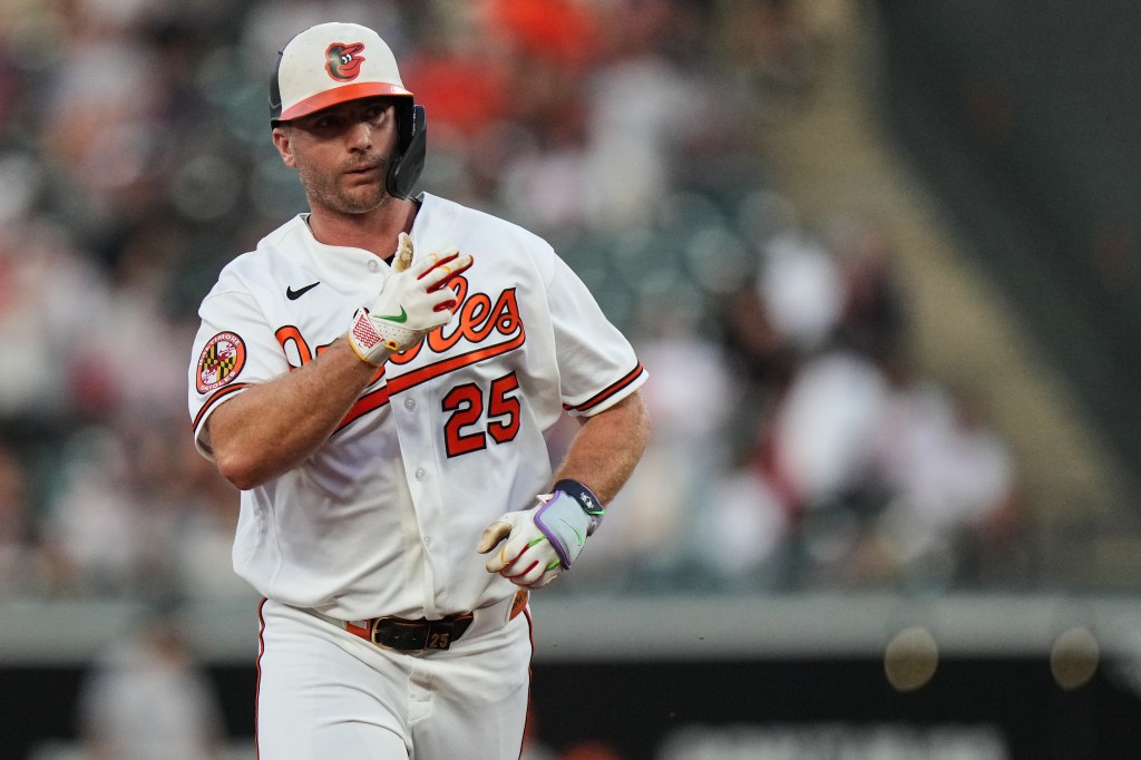 Pete Alonso, wearing a white Baltimore Orioles uniform with number 25, rounding the bases after hitting a home run.