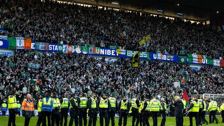 Police had to keep Rangers and Celtic fans apart after they ran onto the pitch at Ibrox in March