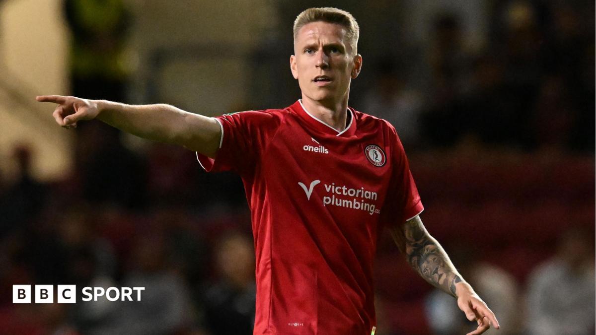 Emil Riis pointing with his right arm while in action for Bristol City