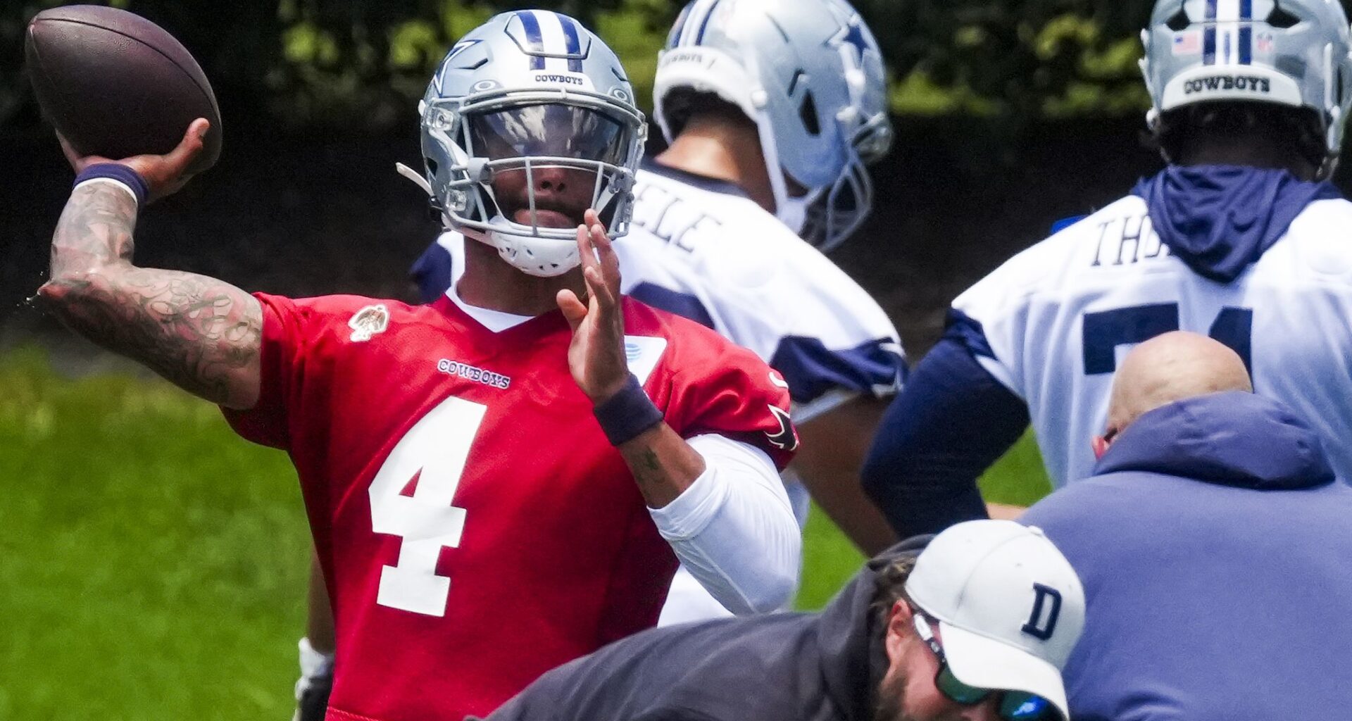 Dallas Cowboys players huddle around quarterback Dak Prescott before of an NFL preseason football game against the Seattle Seahawks, Saturday, Aug. 15, 2026, in Seattle.