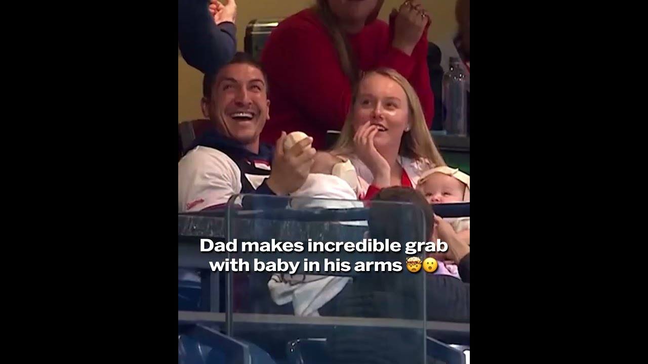 This dad made a wild barehanded snag with his baby in his arms 😮