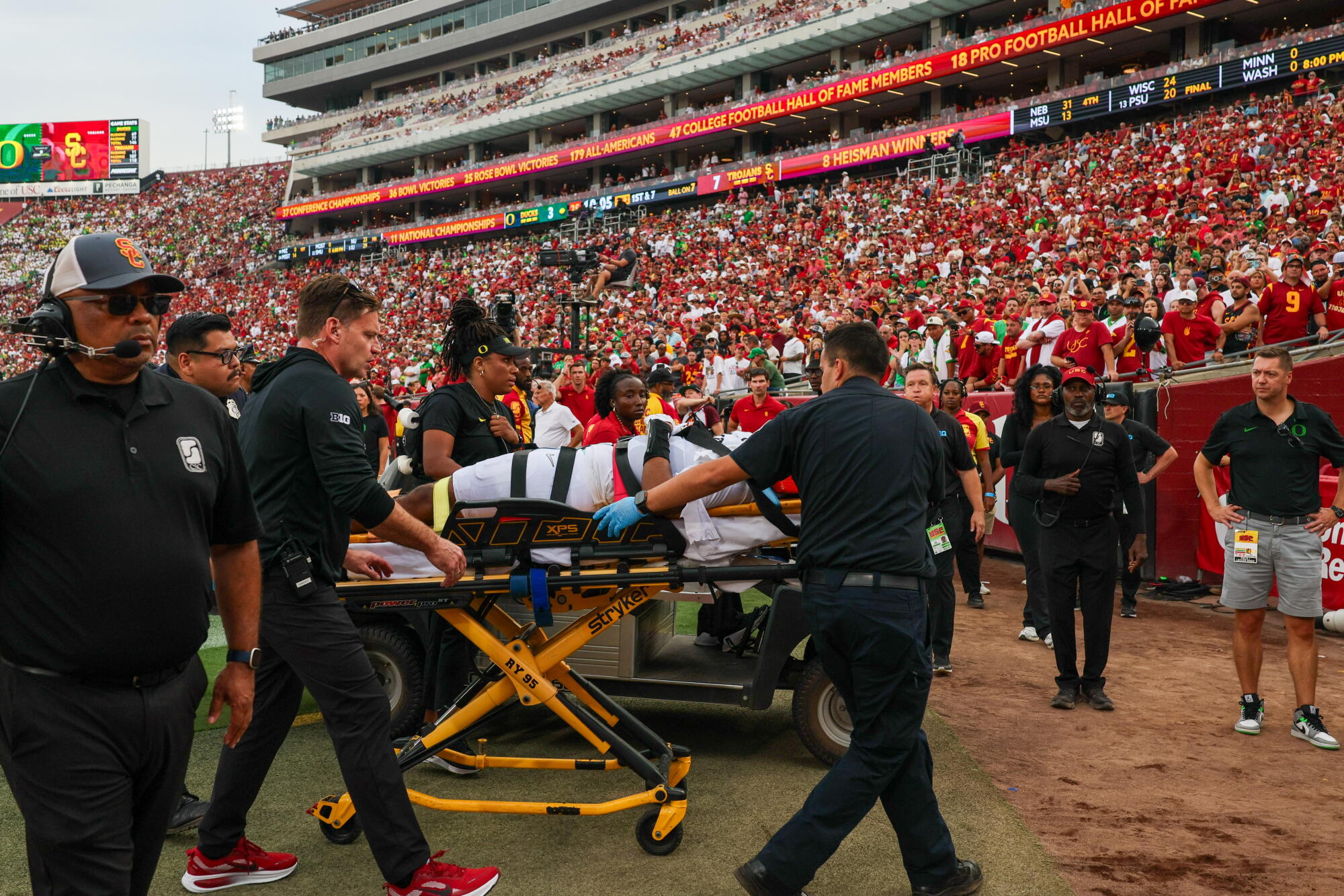Oregon quarterback Dante Moore is taken off the field on a stretcher before being transported to the hospital.