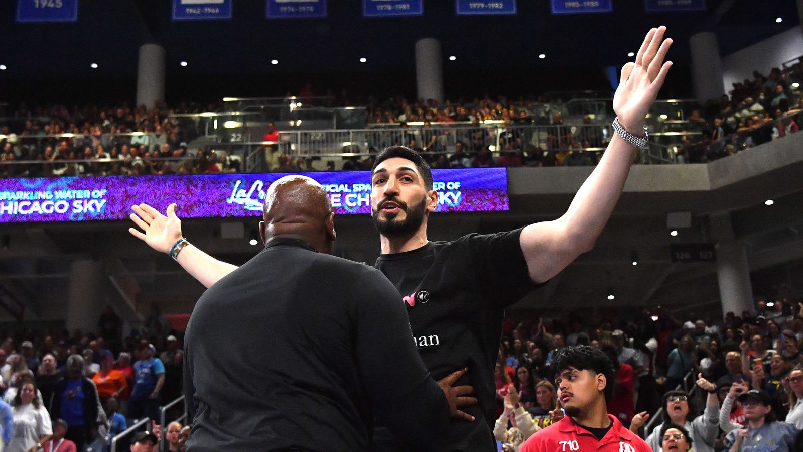 Aug 23, 2026; Chicago, Illinois, USA; Turkish-American former basketball player and human rights activist Enes Kanter Freedom reacts as he is removed from the arena during the second half against the Indiana Fever at Wintrust Arena.