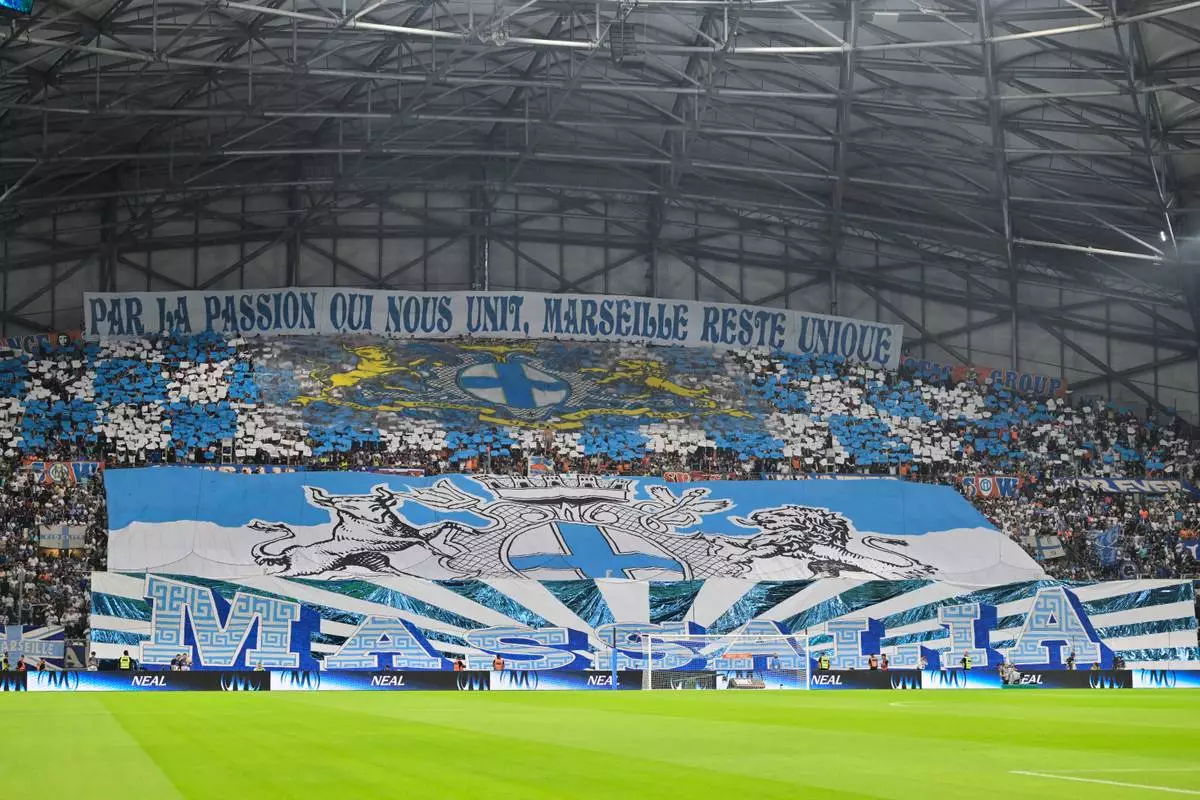 Marseille fans cheer for their team prior to the French League One soccer match between Marseille and Paris Saint-Germain in Marseille, France, Sunday, Sept. 20, 2026. (AP Photo/Philippe Magoni)