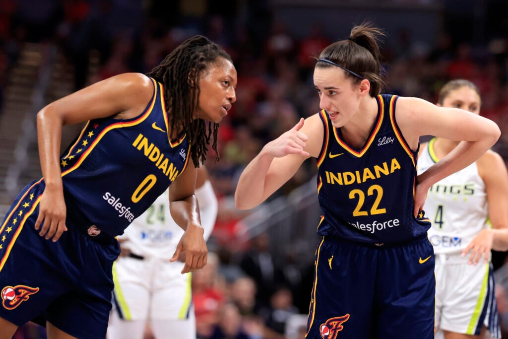 Caitlin Clark #22 of the Indiana Fever speaks with Kelsey Mitchell #0 of the Indiana Fever during the first half against the Dallas Wings