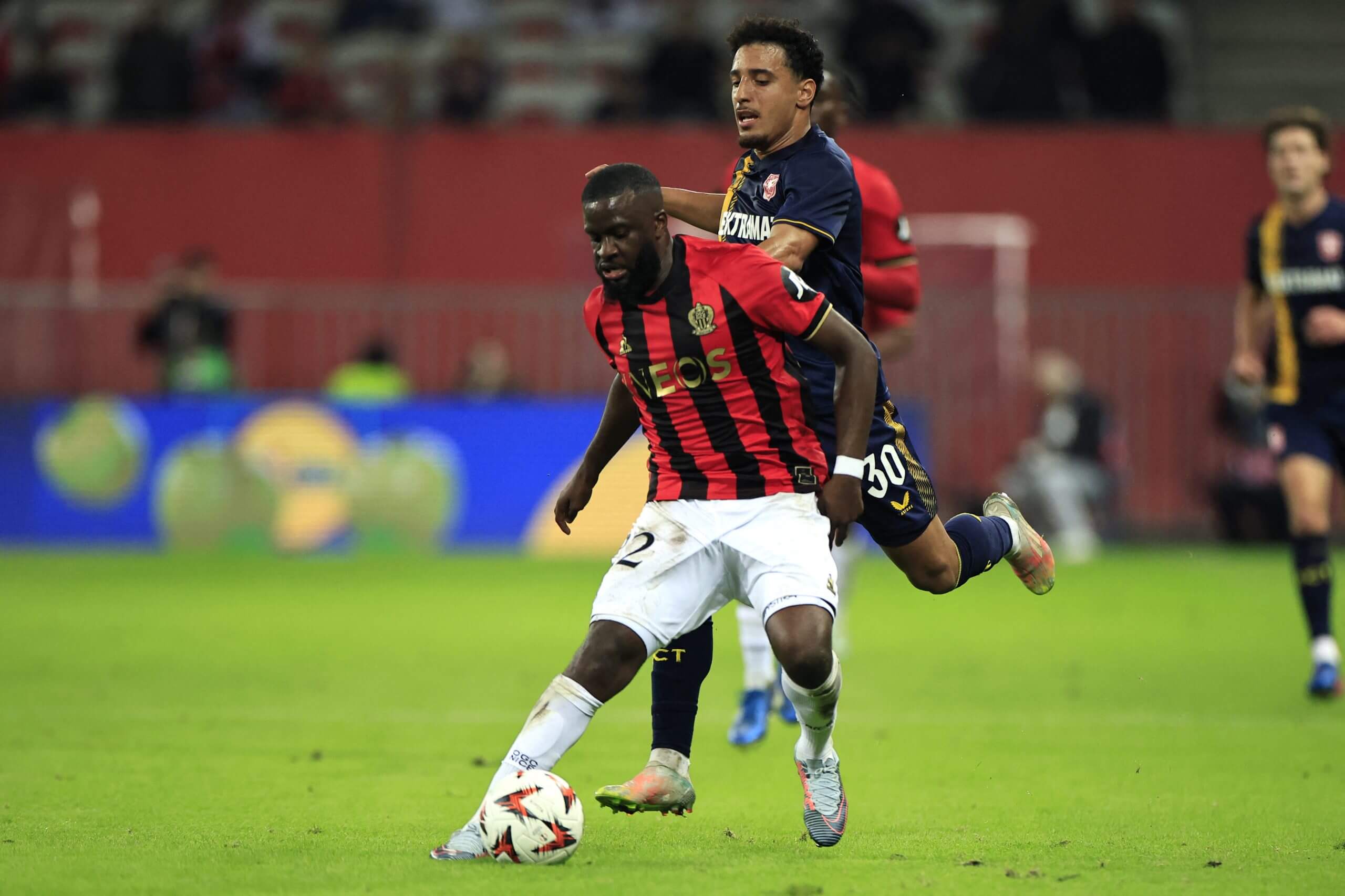 Tanguy Ndombele holds of Twente's Sayfallah Ltaief during a Europa League tie in November 2024