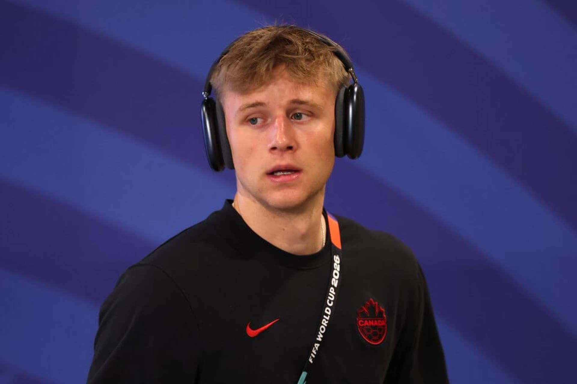 Luc de Fougerolles wearing headphones and a tracksuit