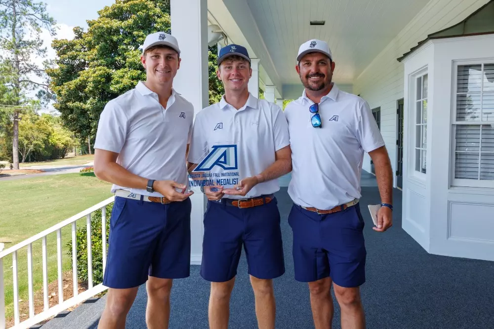 Augusta golfers hold a trophy after winning the Jaguar Fall Invitational