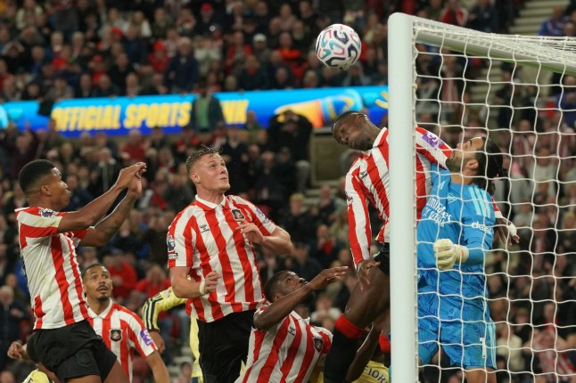 Arsenal's goalkeeper David Raya, right, makes a save in front of Sunderland's Nordi Mukiele during the English Premier League soccer match between Sunderland and Arsenal in Sunderland, England, Saturday, Sept. 12, 2026. (AP Photo/Ian Hodgson)