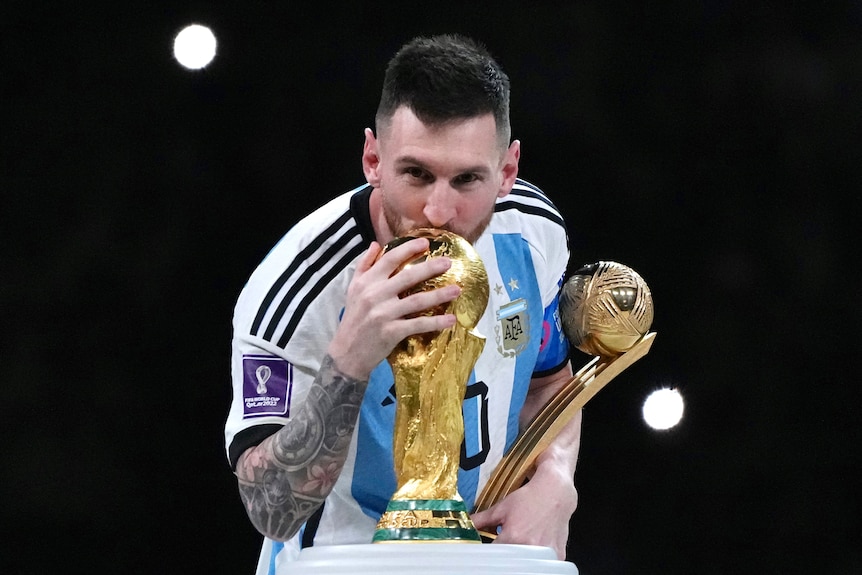 Lionel Messi of Argentina kisses the FIFA World Cup Winner's Trophy