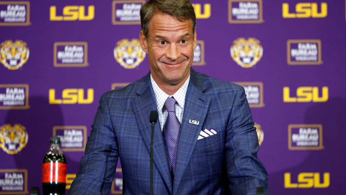 Lane Kiffin speaking at a press conference at Tiger Stadium in Baton Rouge, Louisiana