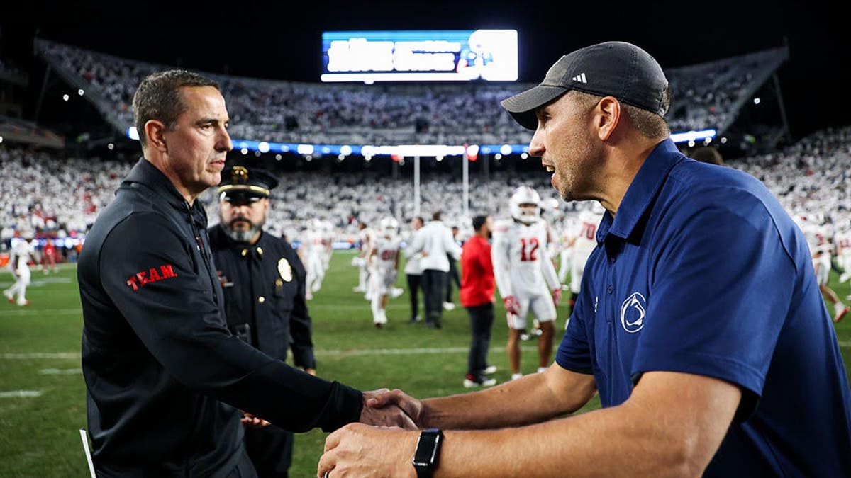 Luke Fickell shakes hands with Matt Campbell after the game at Beaver Stadium.