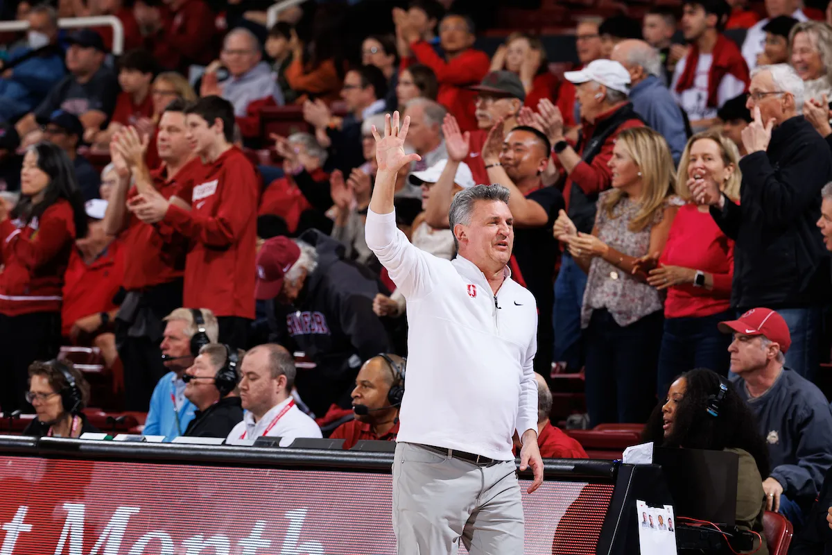 Kyle guy on the court with his hand in the air.