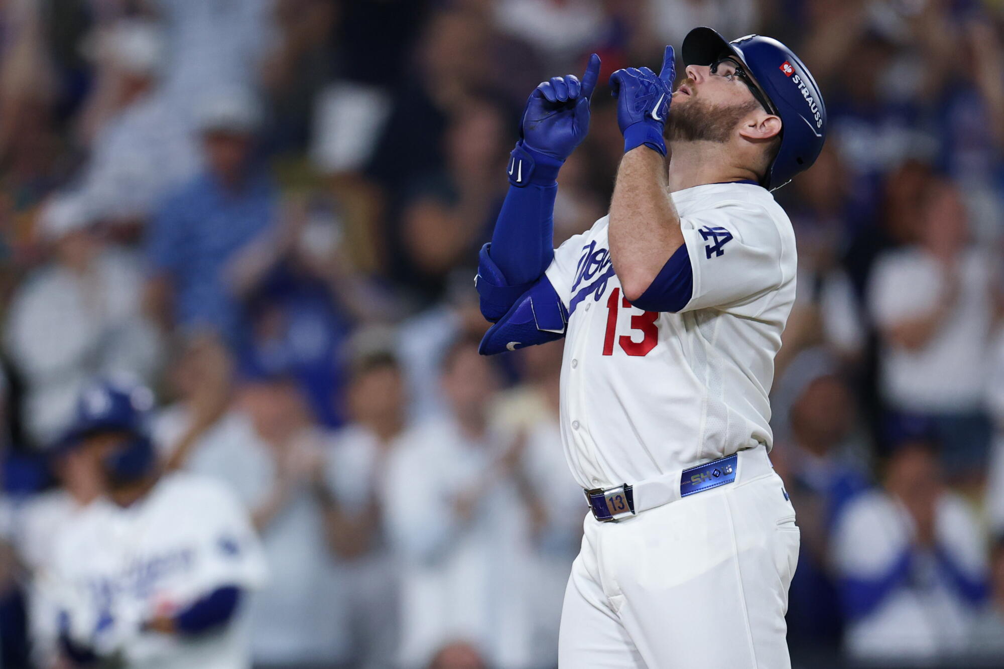 Max Muncy celebrates while crossing home plate after a solo home run during the ninth inning Sunday.