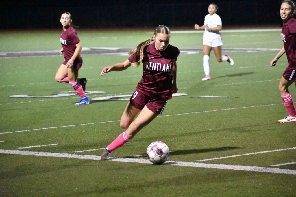 Adalyn Sagen runs with the ball at her feet for Kentlake. Ben Ray / The Reporter