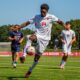 Junior forward Xavier Tanyi wrangles control of the ball during a match against the University of Connecticut.
