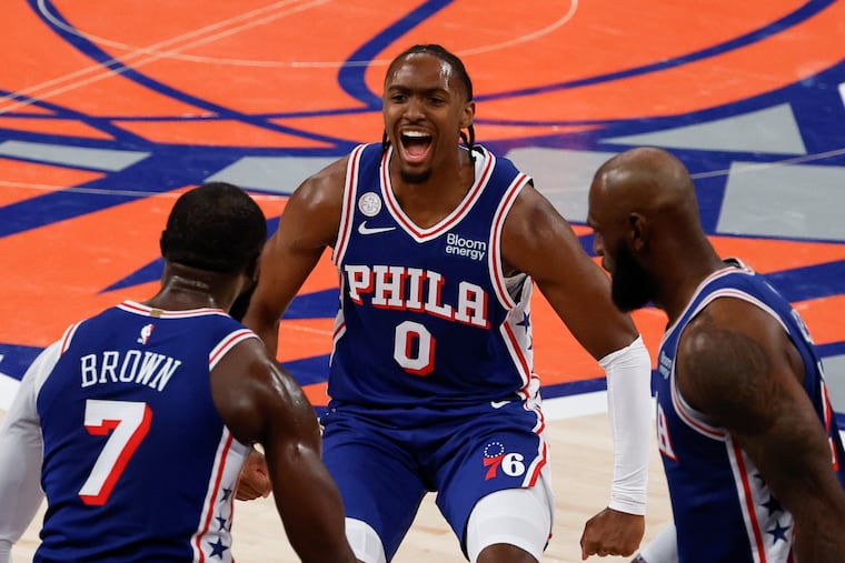 Tyrese Maxey, Jaylen Brown, and LeBron James celebrate during the Sixers' season-opening win on Tuesday.