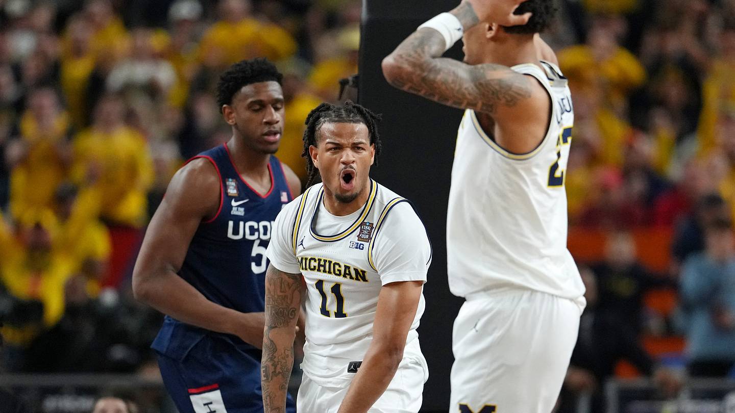 Apr 6, 2026; Indianapolis, IN, USA; Michigan Wolverines guard Roddy Gayle Jr. (11) reacts after a dunk against the UConn Huskies during the first half in the national championship of the Final Four of the men's 2026 NCAA Tournament between the  and the Michigan Wolverines at Lucas Oil Stadium. Mandatory Credit: Bob Donnan-Imagn Images
