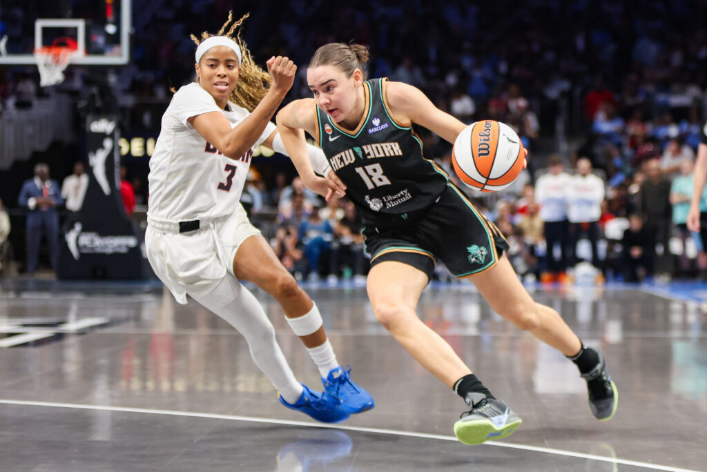 New York Liberty guard Pauline Astier (18) drives past Atlanta Dream guard Jordin Canada (3) in the first quarter during game one of the second round for the 2026 WNBA Playoffs at State Farm Arena.