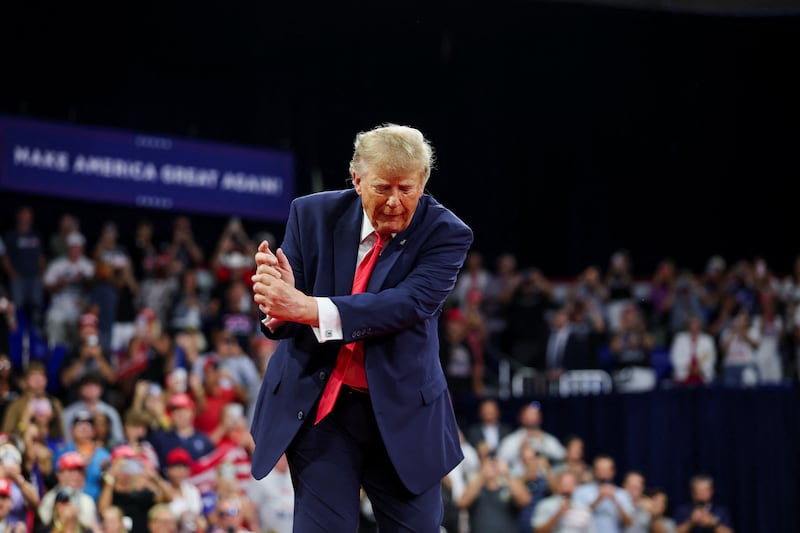 US President Donald Trump mimics a golf swing after speaking during a rally at Florida Gulf Coast University's Alico Arena ahead of the midterm elections, in Fort Myers, Florida, US, October 23, 2026.