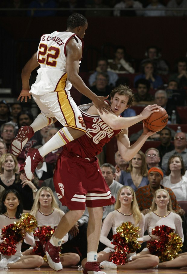 LOS ANGELES - FEBRUARY 19: Dan Grunfeld #20 of Stanford gets out of the way from the defense of Errick Craven #22 of USC during the game at the Sports Arena, on February 19, 2004 in Los Angeles, California. (Photo by Harry How/Getty Images)