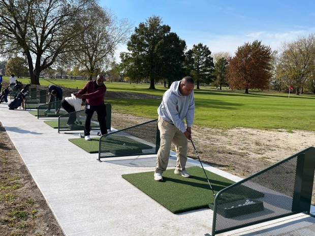 Gary officials, including Councilman Dwight Williams, D-6th, and COO Michael Suggs, tee off following the opening of the South Gleason Park Golf Range on Tuesday, Oct. 27, 2026. The $173,000 investment is the second upgrade to Gleason Park. (Maya Wilkins/Post-Tribune)