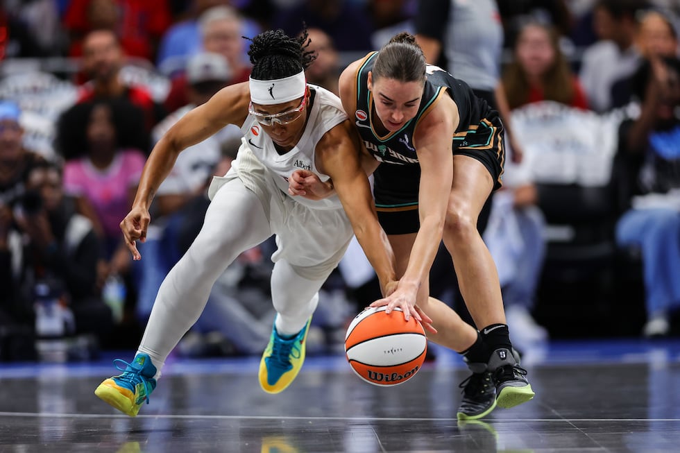 Atlanta Dream guard Allisha Gray, left, fights for possession with New York Liberty guard...