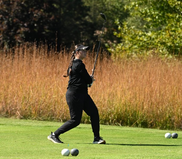 Romeo's Braylyn Udvari gives her drive a little body english Wednesday at the Division 1 Twin Lakes girls golf regional on Oct. 7, 2026. (DAN STICKRADT -- MediaNews Group)