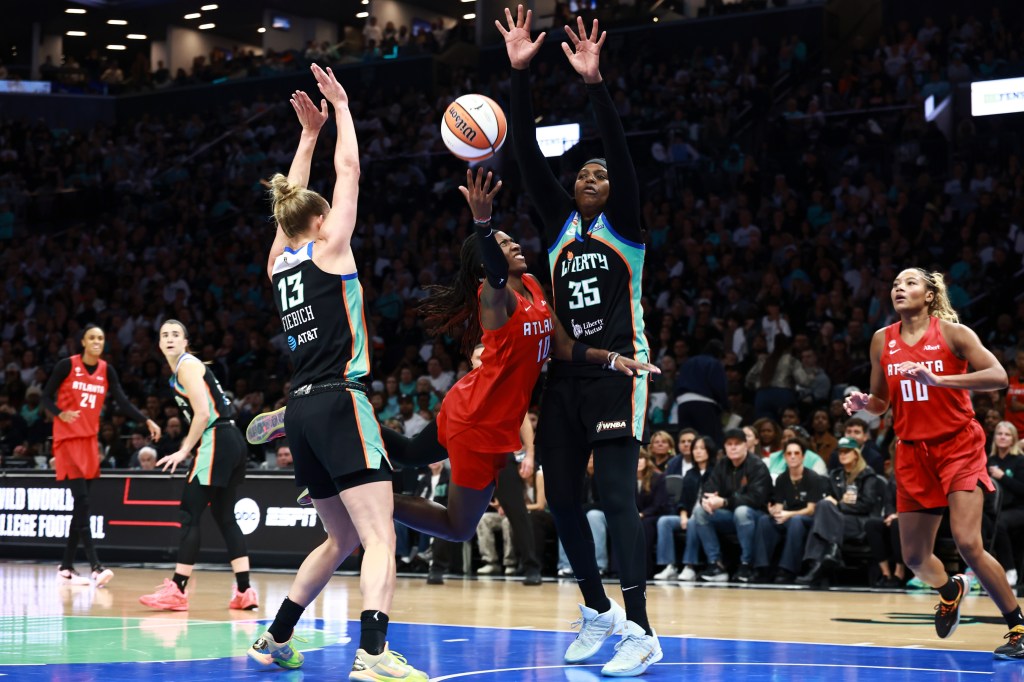 Atlanta Dream guard Rhyne Howard shoots against New York Liberty forward Jonquel Jones during a WNBA playoff game.