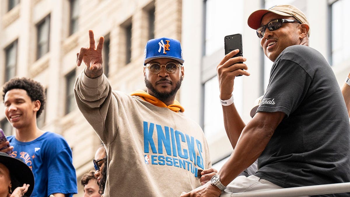 Carmelo Anthony and John Starks stand on a float during the New York Knicks championship parade.
