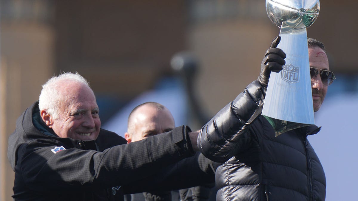 Philadelphia Eagles general manager Howie Roseman with the Vince Lombardi Trophy as owner Jeffrey Lurie looks on during the Super Bowl LIX championship parade and rally on Feb. 14, 2025.