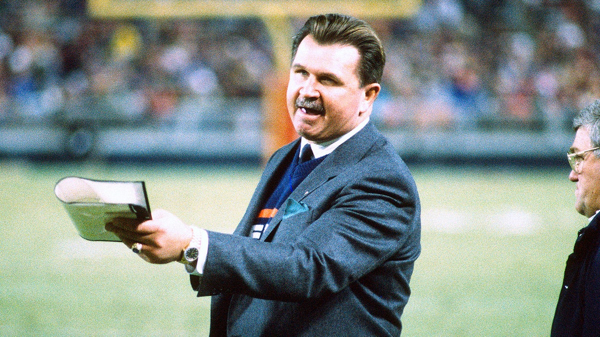 Mike Ditka looks on