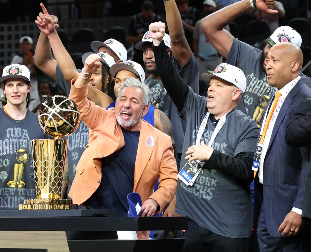 New York Knicks owner James Dolan celebrates after winning the NBA Championship alongside team members and staff.