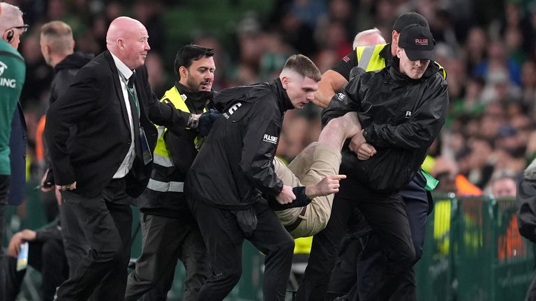 A protestor was carried off the pitch during the game